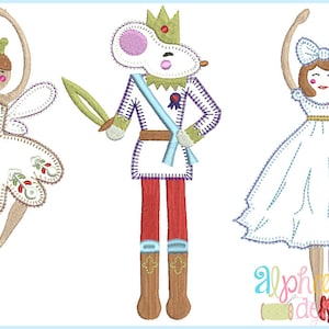 May include: Three embroidered figures: a ballerina fairy with a white tutu and floral accents, a mouse soldier in a white uniform with a blue sash and a sword, and a ballerina in a white dress with a blue bow.