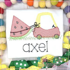May include: Embroidered design of a red toy car pulling a watermelon with the name "axel" underneath. The design is on a white t-shirt.