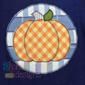 May include: A patchwork pumpkin applique with a yellow and orange checkered pattern, surrounded by a blue and white checkered circle. The applique is perfect for a fall-themed craft project.