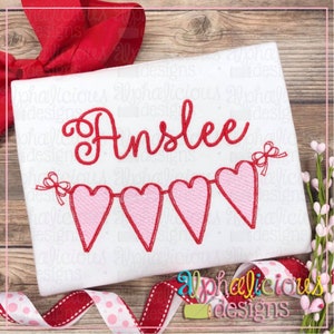 May include: Embroidered design featuring the name "Anslee" in red cursive script with a string of pink hearts with red outlines and red bows.