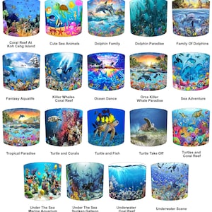 May include: A selection of lampshades depicting underwater scenes. Designs include coral reefs, dolphins, sea turtles, and various marine life. Each lampshade showcases a unique aquatic environment with vivid colours and detailed illustrations.