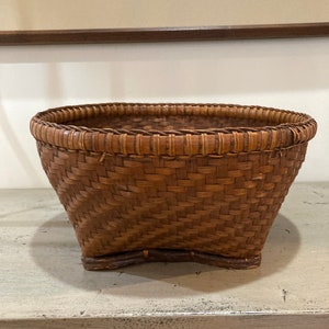 Vintage Rattan Round Basket with Unique Bottom.