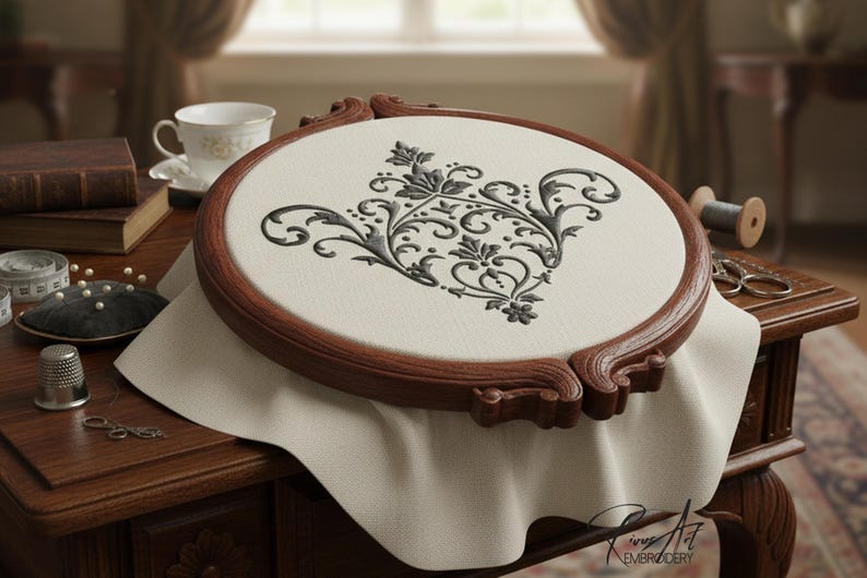 May include: A detailed embroidery project in a wooden hoop. The design features a black floral pattern on a cream-colored fabric. The wooden hoop is a rich brown color. Other sewing supplies are on the table.
