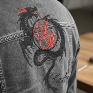 May include: A gray denim jacket features a large black dragon embroidery on the back, with red accents on the dragon's head and a circular patch with red initials. The jacket has visible stitching and the embroidered text "Rives Art EMBROIDERY".