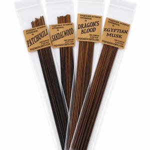 May include: Four clear plastic sleeves containing brown incense sticks, each with a tan label reading PSQUARE SCENTS PITTSBURGH, PA, followed by the scent names Patchouli, Sandalwood, Dragon's Blood, and Egyptian Musk, plus the website PSQUARESCENTS.COM.