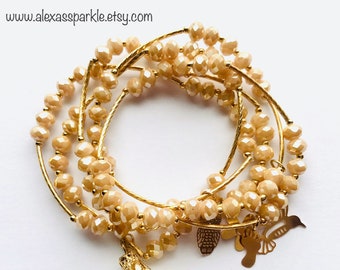 Beige Crystal Bracelet Set with gold plated charms - Pulseras de Cristal Beige con dijes de chapa de oro