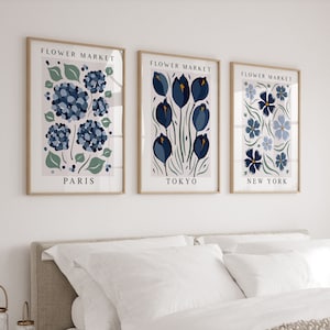 May include: Three framed prints with the text "Flower Market" above floral illustrations. The prints are labeled "Paris", "Tokyo", and "New York".