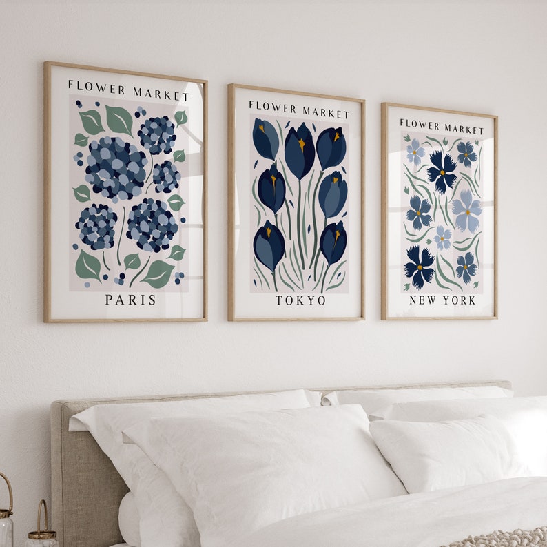 May include: Three framed prints with the text "Flower Market" above floral illustrations. The prints are labeled "Paris", "Tokyo", and "New York".
