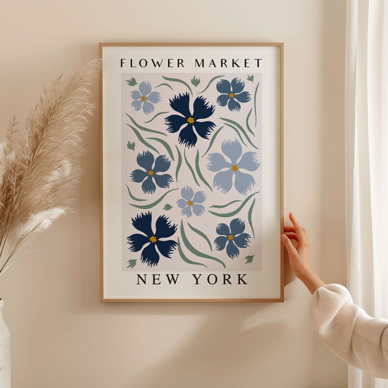 May include: A framed print with a floral design in shades of blue and green. The print features the text "FLOWER MARKET NEW YORK".