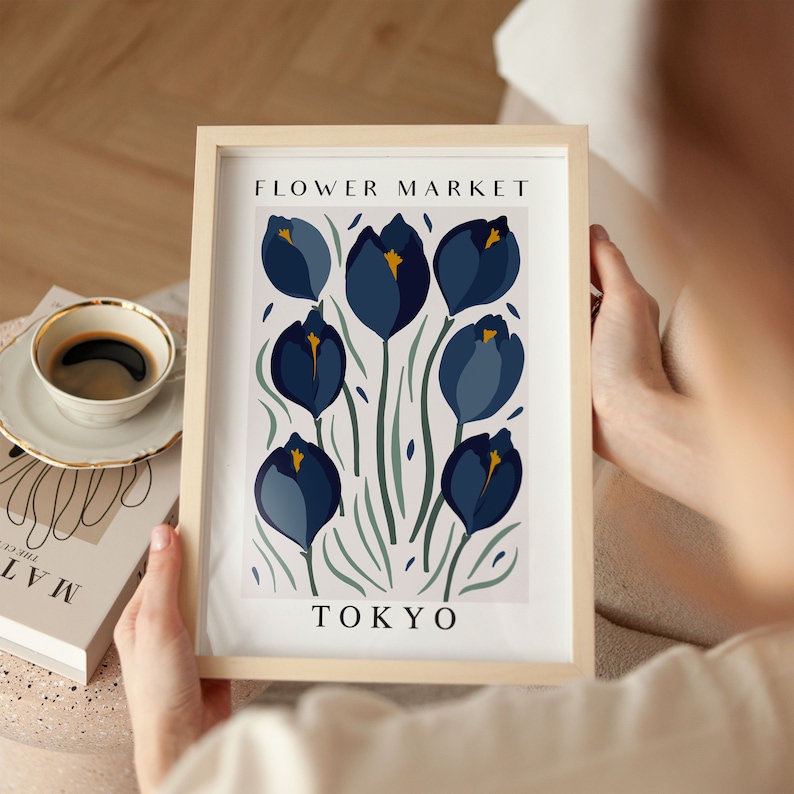 May include: A framed print with a floral design featuring blue and yellow flowers with green stems on a white background. The print has the text "FLOWER MARKET TOKYO" at the top and bottom.