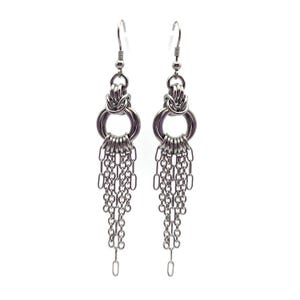 May include: A pair of silver-toned dangle earrings. Each earring features a chainmail-style design with multiple small rings and dangling chains. The earrings have a hook closure and are set against a white background.