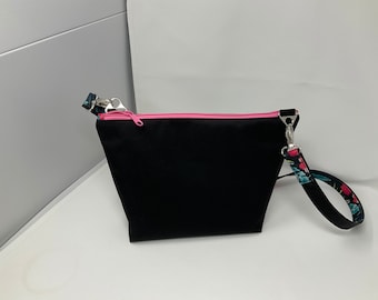 Black waterproof canvas crossbody bag with a pop of color.