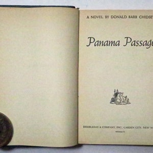 May include: A vintage book titled "Panama Passage" by Donald Barr Chidsey. The book cover features a black and white illustration of a castle with a flag.