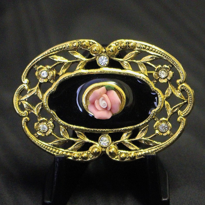Vintage Oval Brooch Pin Black Enamel with Pink Rosebud Openwork Trailing Flower Stems Frame with Ice Rhinestone Centres with scalloped Rim