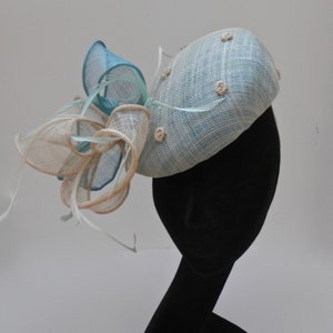 Elegant formal beret style wedding, races hat, perch hat with feather and sinamay swirl trim.