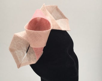 Half halo headband in the style of a bow in pinks