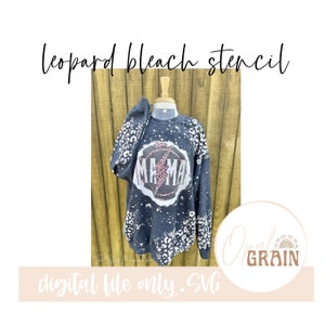 May include: A digital file for a leopard print bleach stencil design featuring the text "Mama" with a lightning bolt inside a circle. The design is on a gray sweatshirt.