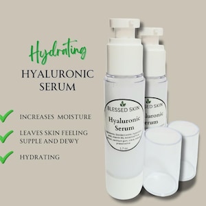 May include: Two clear plastic pump bottles of Blessed Skin Hyaluronic Serum with white caps. The label lists ingredients and 1.7 oz volume. Text reads: Hydrating, Hyaluronic Serum, Increases Moisture, Leaves Skin Feeling Supple and Dewy, Hydrating.