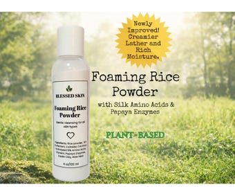 May include: A white bottle of Blessed Skin Foaming Rice Powder, 4 oz, with a white cap. The label includes text about the product's ingredients and benefits, such as silk amino acids and papaya enzymes. The background is a blurred green field.