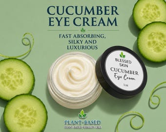 May include: A 1 oz jar of white cucumber eye cream with a black lid, labeled Blessed Skin Cucumber Eye Cream. The jar is open, revealing the cream, and is surrounded by sliced cucumbers and green vines on a light green background.