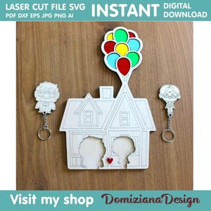 May include: A laser cut SVG file design of a house with balloons, two characters, and the text "LASER CUT FILE SVG INSTANT DIGITAL DOWNLOAD".