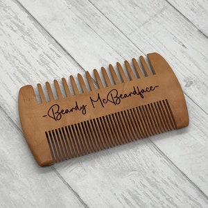 May include: A wooden beard comb with the text "Beardy McBeardface" engraved on it.