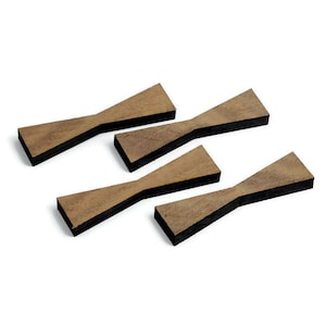May include: Four wooden bow tie shaped coasters with a black backing.