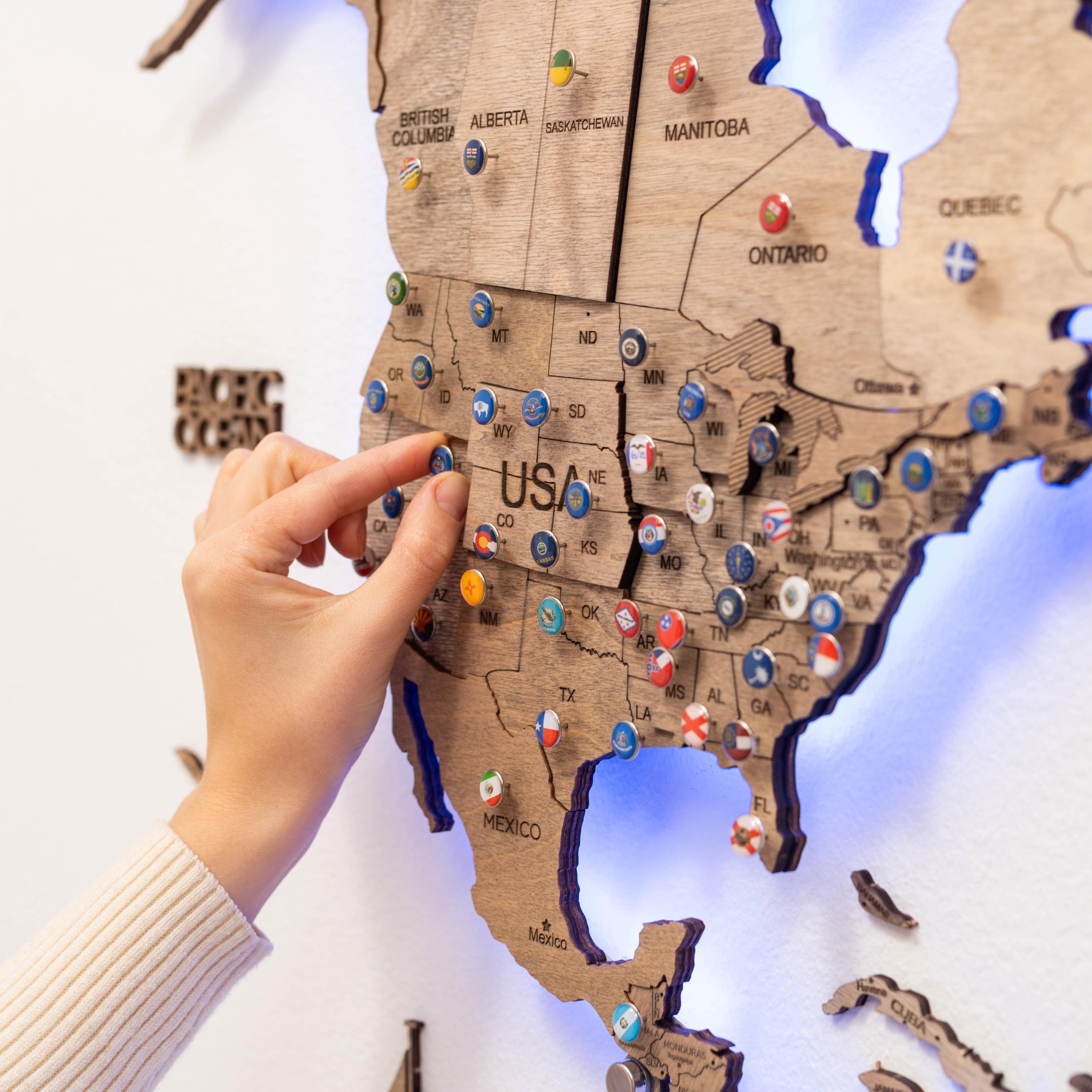 Wooden world map with push pins for home decor.