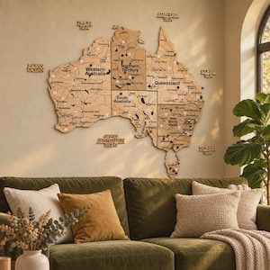 May include: A large wooden wall map of Australia featuring detailed state boundaries, major cities, roads, and surrounding seas. The map is segmented into sections with various coloured push pins inserted into specific locations across the continent.