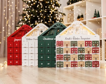 May include: Four wooden advent calendars in red, white, and green, shaped like houses. Each calendar has numbered doors for each day of December leading up to Christmas. The calendars are personalized with names.