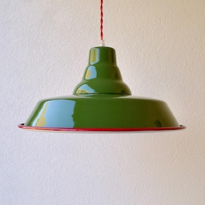 May include: A glossy green pendant light fixture with a wide, tiered dome shade and a thin red rim. The light hangs from a twisted red cord. The text "red cord" is visible in the upper left corner of the image, indicating the cord color.