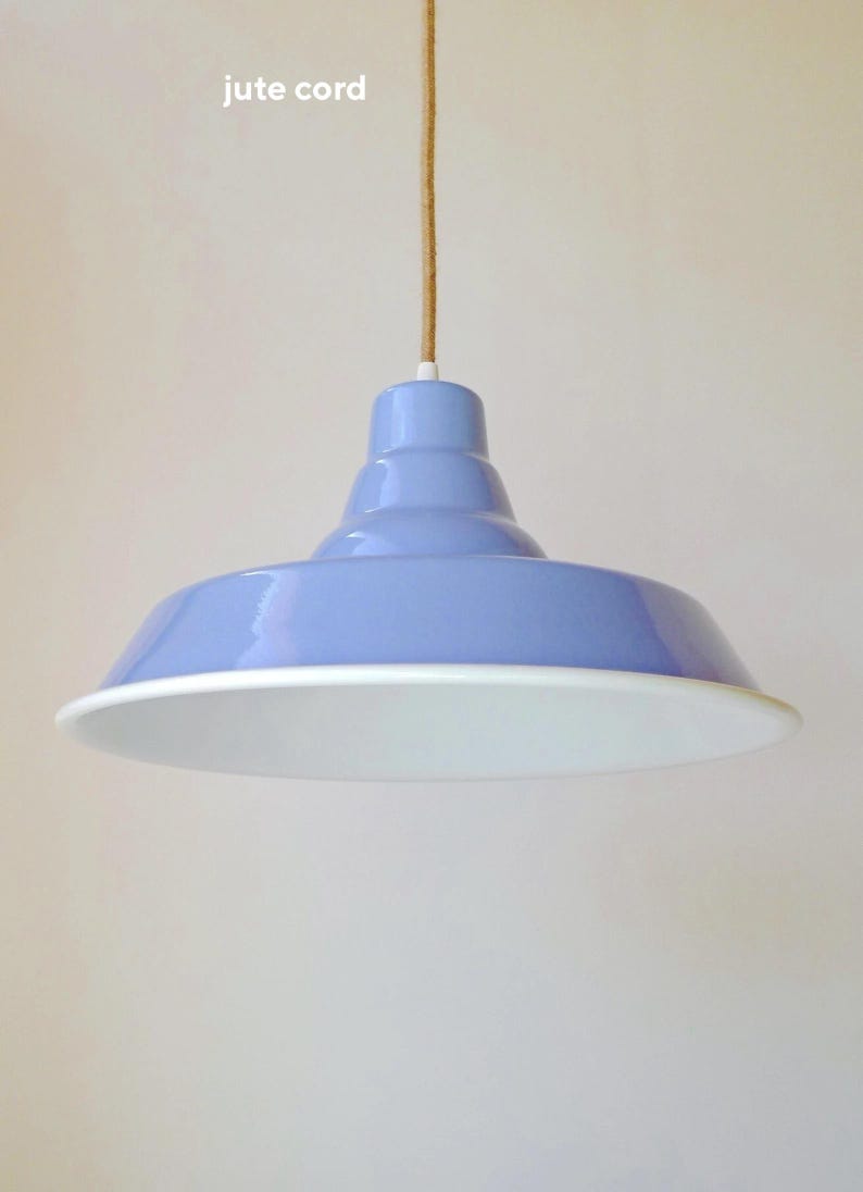 May include: A light blue pendant light fixture with a glossy finish and a wide, flared shade. The interior of the shade is white. The fixture is suspended from a natural tan jute cord. The text "jute cord" is visible in the upper left corner.
