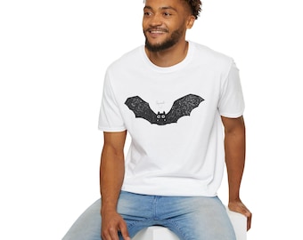May include: White t-shirt featuring a black bat graphic with the word "Squeak" above it. The bat has large wings and two small eyes. The shirt is made of a soft material.