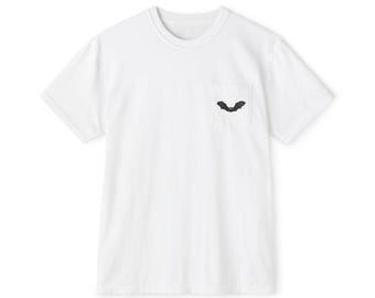 May include: A white t-shirt with a small pocket on the chest. The pocket features a black bat design. The shirt has short sleeves and a crew neck. The t-shirt is made of a soft, lightweight material.