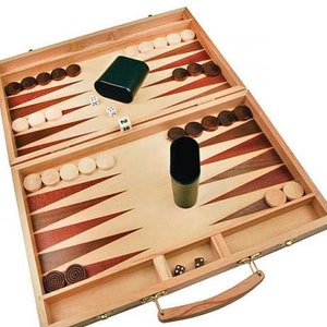 May include: A wooden backgammon set with a brown and red playing surface, two dice, and two black cups. The set is closed and has a handle.