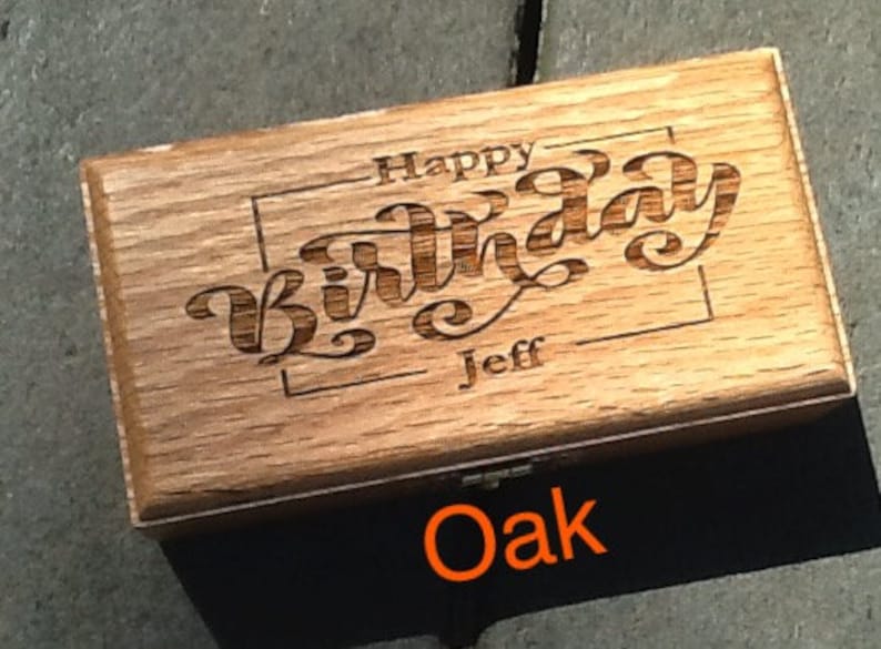 May include: A wooden box with the words 'Happy Birthday Jeff' engraved on the top. The box is made of oak wood and has a natural wood finish.