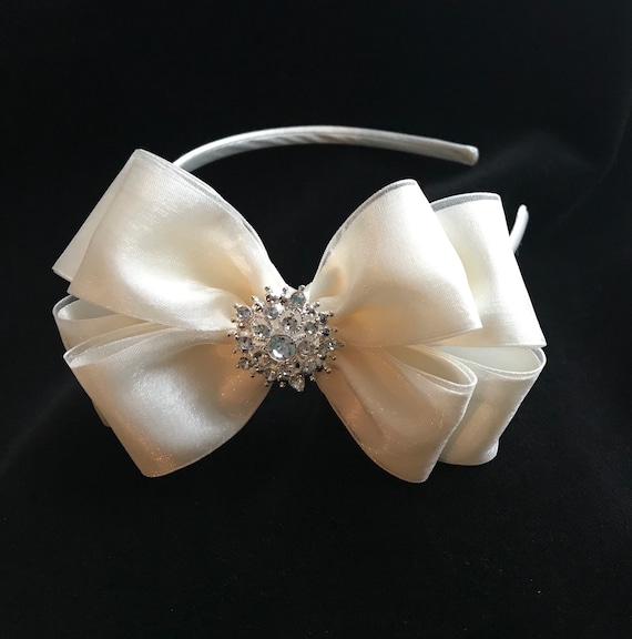 Red and white flower girls hair bow with purple satin flower centre handmade