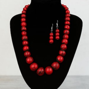 Hand-gilded for a one-of-a-kind red/black colored necklace
