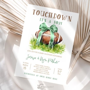 May include: Baby shower invitation with a football theme. The invitation features a watercolour illustration of a brown football with a green bow and grass. Text includes "Touchdown, It's a Boy!" and event details.