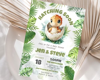 May include: Baby shower invitation featuring a watercolour illustration of a baby dinosaur emerging from an egg. The invitation includes the text "Hatching Soon" and details for Jen & Steve's baby shower, including the date, time, and location.
