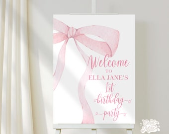 May include: Pink watercolor bow with a white background. The text reads "Welcome to Ella Jane's 1st birthday party".