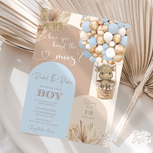May include: A blue and brown baby shower invitation with a cartoon highland cow in a hot air balloon made of blue and gold balloons. The text reads "Have you heard the moos?" and "Rachel & Parker are having a baby boy".