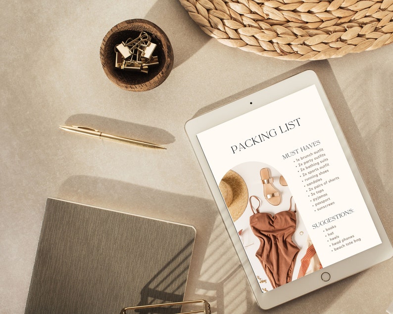 Może przedstawiać: Tablet cyfrowy wyświetlający listę rzeczy do spakowania na wycieczkę. Lista zawiera "Must Haves" i "Suggestions" dotyczące rzeczy do spakowania. Na zdjęciu widać r&oacute;wnież słomkowy kapelusz, sandały i kostium kąpielowy.