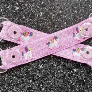 Pink unicorn elasticated mitten clips.no more lost gloves! Clip onto coat/cuff. Plastic kam clips.clip together when not in use.