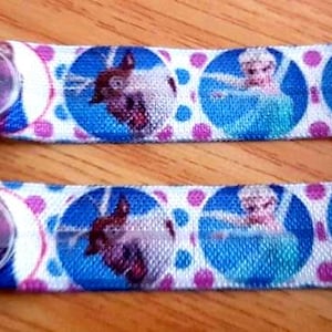 Clips voor wanten en handschoenen Frozen Elsa Ana-ontwerp elastisch lint. Clips aan jas. Geen verloren handschoenen meer! Wordt aan jas en handschoen bevestigd.