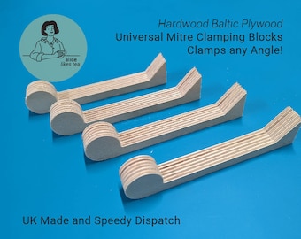 May include: Four wooden miter clamping blocks made of Baltic plywood. The blocks are designed to clamp at any angle. The text "Hardwood Baltic Plywood Universal Mitre Clamping Blocks Clamps any Angle!" is printed above the blocks. The text "UK Made and Speedy Dispatch" is printed below the blocks.