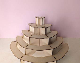 May include: A wooden tiered display stand with five levels, each shaped like a half-circle. The stand is made of light brown wood and has a natural finish.