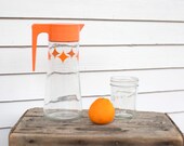 vintage Anchor Hocking water carafe, juice pitcher with orange lid -- atomic star burst pattern, 1960-70's kitchen wares