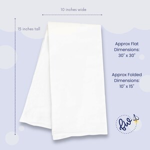 May include: A white cotton tea towel folded in half, measuring 15 inches tall and 10 inches wide. The towel is flat and unfolded, showing its full size. The text "Approx Flat Dimensions: 30" x 30"" and "Approx Folded Dimensions: 10" x 15"" is visible in the image.