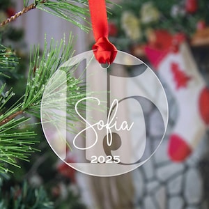 May include: Clear glass Christmas ornament with the number 15, the name Sofia, and the year 2025 printed in white.